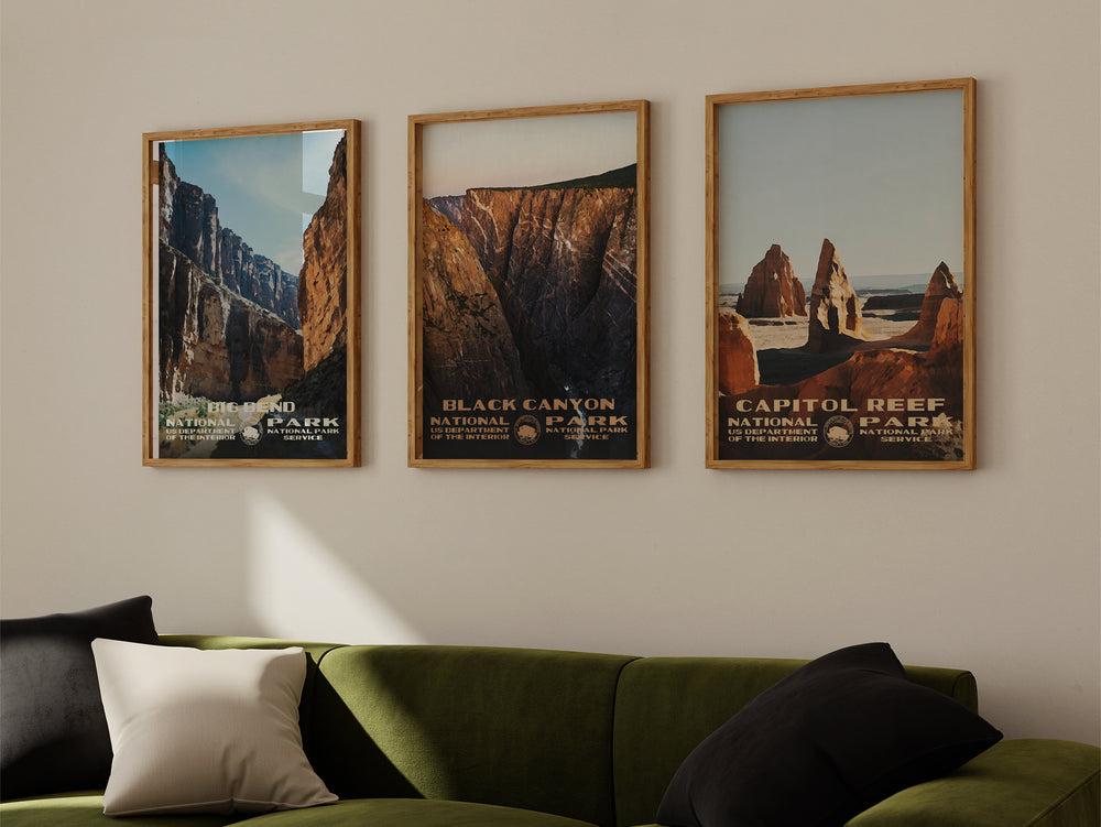a living room with a green couch and three pictures on the wall