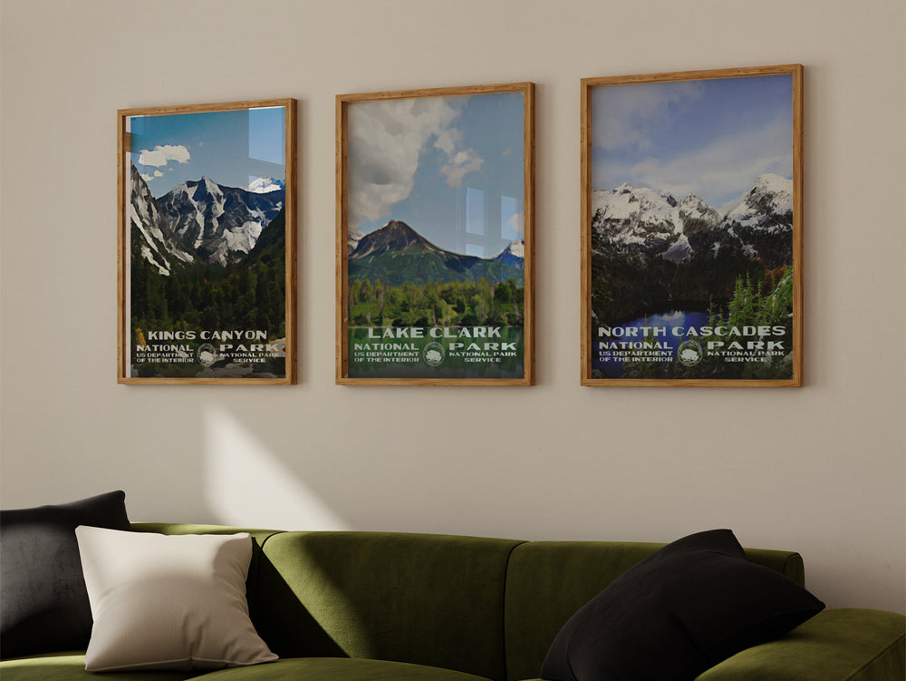 a living room with a green couch and three framed pictures on the wall