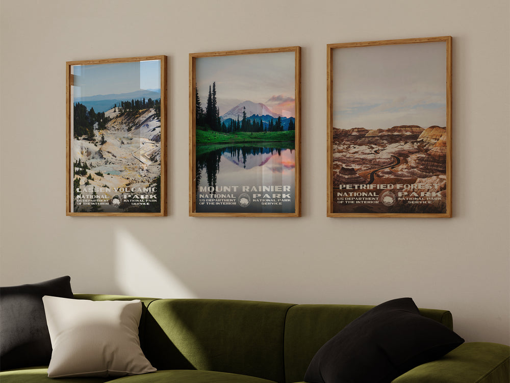 a living room with a green couch and three pictures on the wall