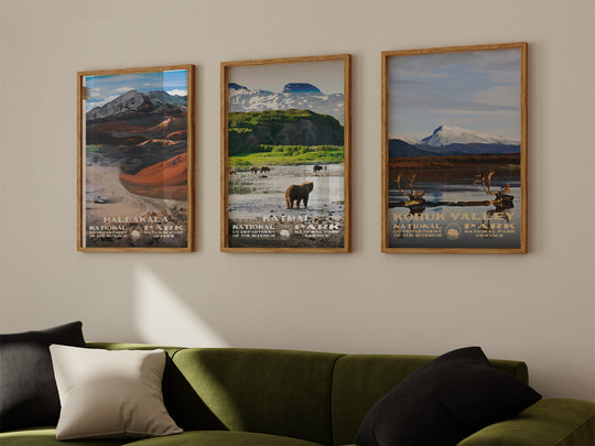 a living room with a green couch and three posters on the wall