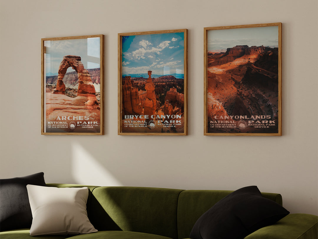 a living room with a green couch and three posters on the wall