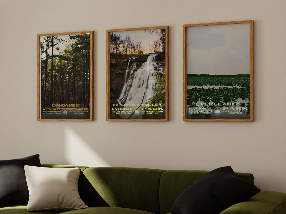 a living room with a green couch and two pictures on the wall