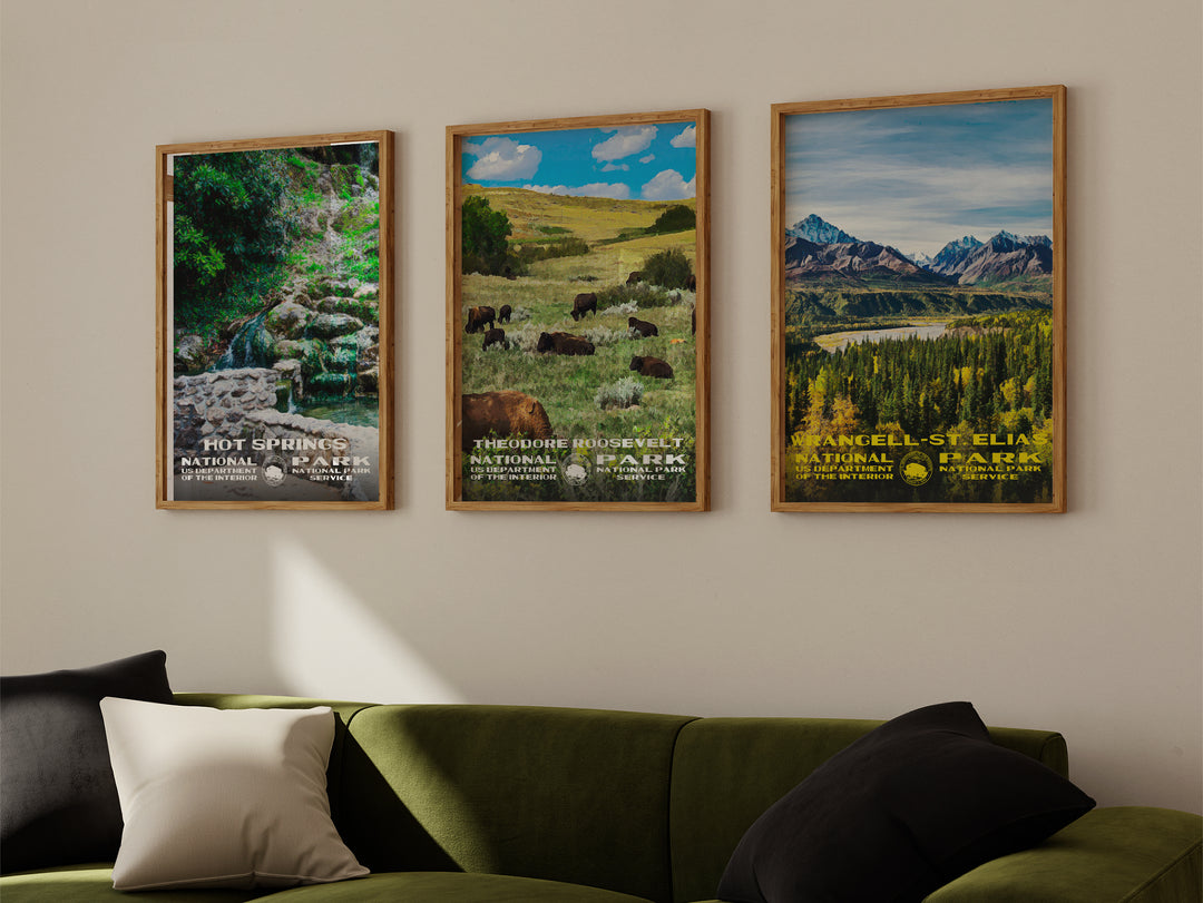 a living room with a green couch and three posters on the wall