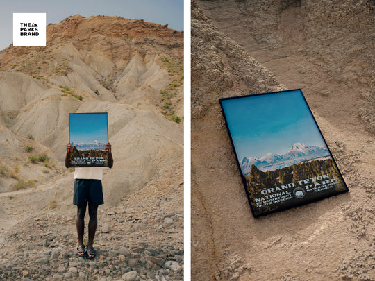 a person holding up a picture of a mountain