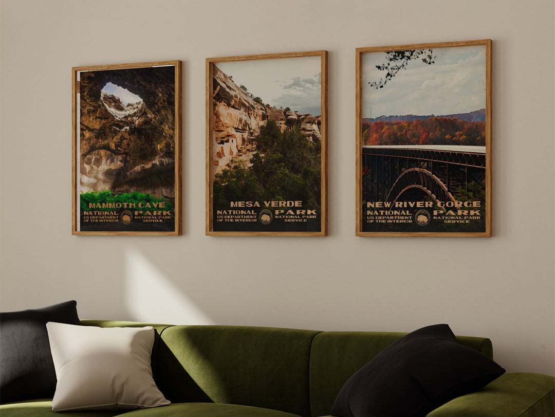 a living room with a green couch and three posters on the wall