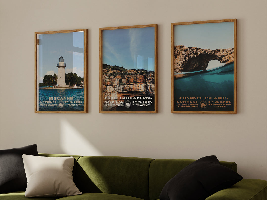 a living room with a green couch and three framed pictures on the wall