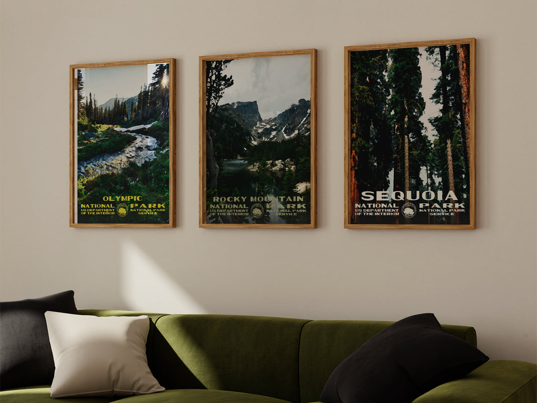 a living room with a green couch and two posters on the wall