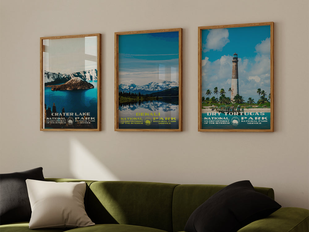 a living room with a green couch and three posters on the wall